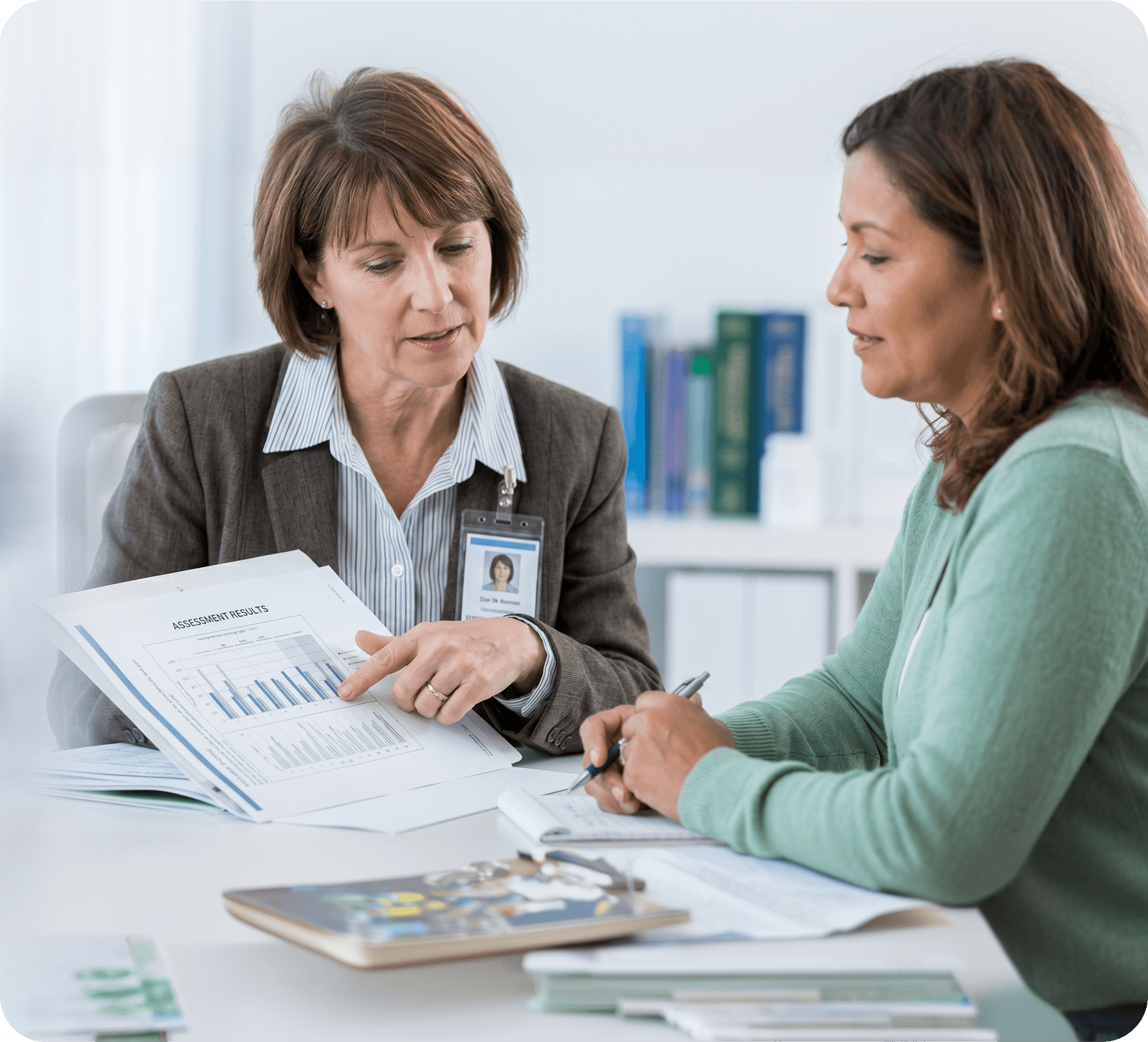 Two colleagues reviewing assessment results together at a desk